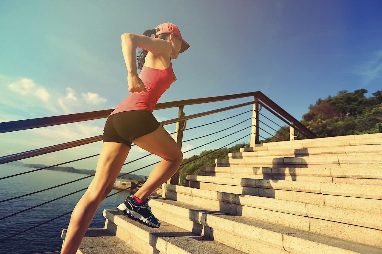 A runner taking the stairs by the sea